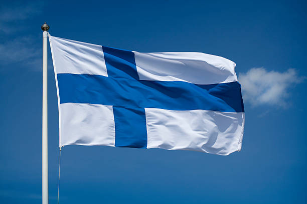hoisted finnish flag with a blue sky background 2 3