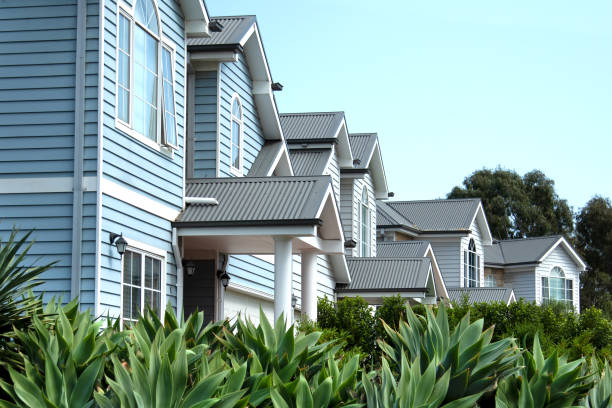 Frontal view of double-story townhouses characterized by their distinctive weatherboard wall cladding and corrugated metal roofs